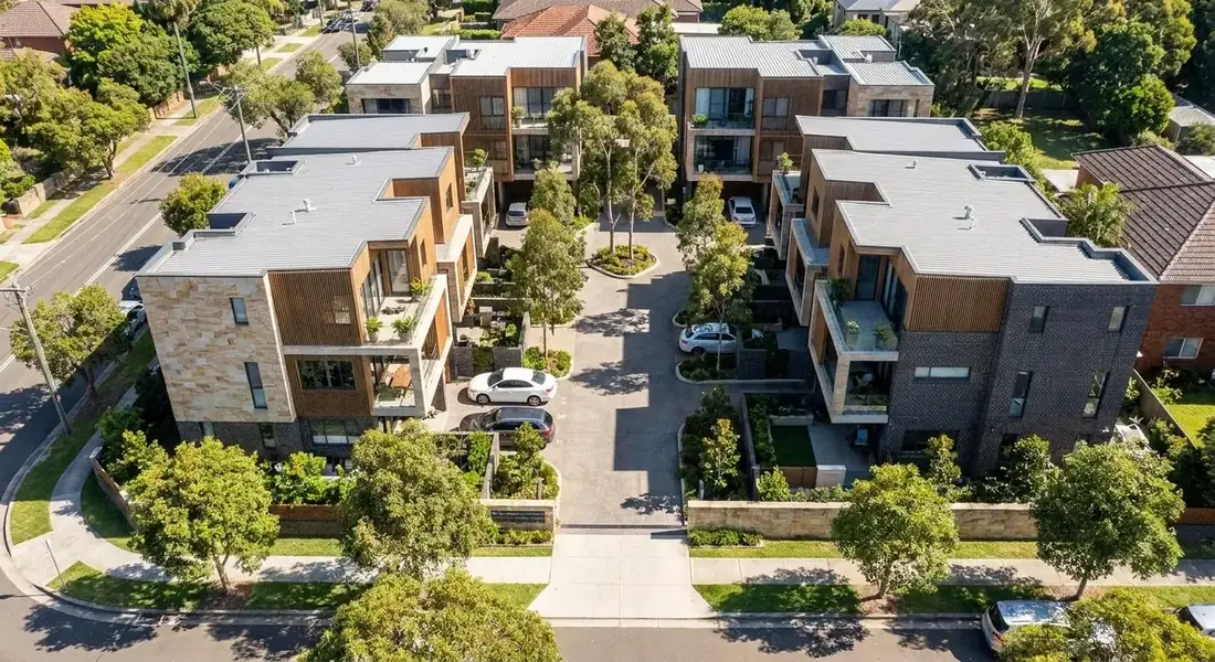 Aerial photograph of a completed 12-townhouse development with sandstone and timber detailing