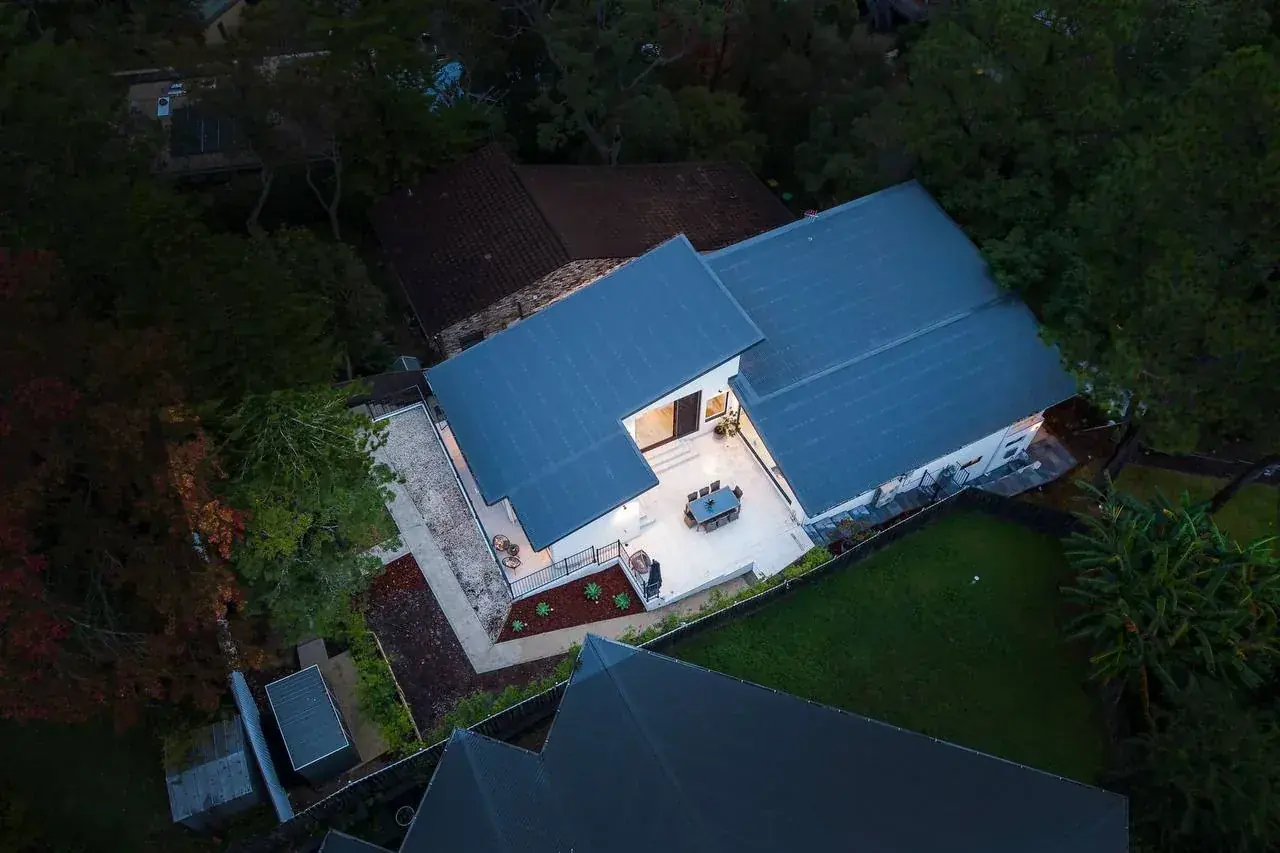 Aerial view showing the stepped roof planes and the sheltered courtyard between them