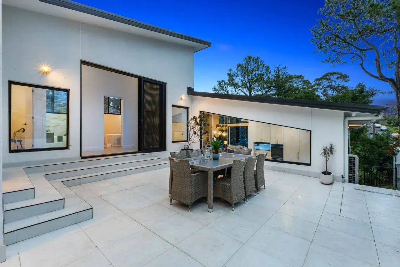 The approved rear alfresco terrace at dusk, opening off the kitchen